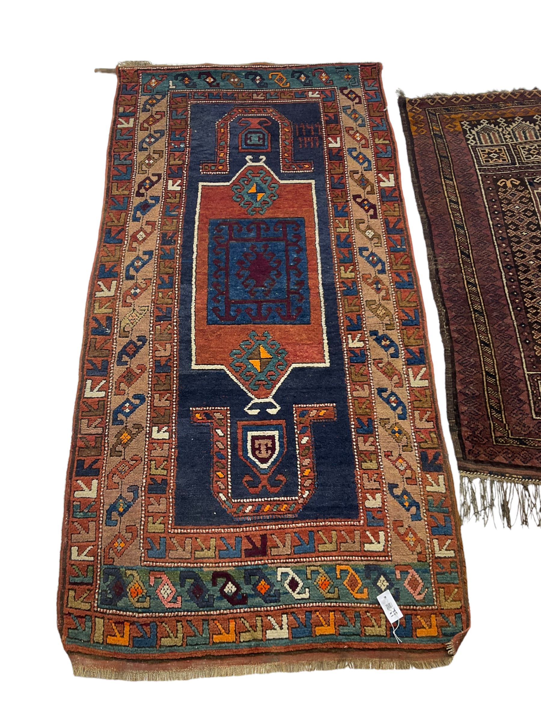 Turkish rug or wall hanging, blue ground field with decorative panels, with geometric motifs and multi-band border (207cm x 104cm), and a prayer rug with repeating border and geometric motifs (150cm x 92cm)