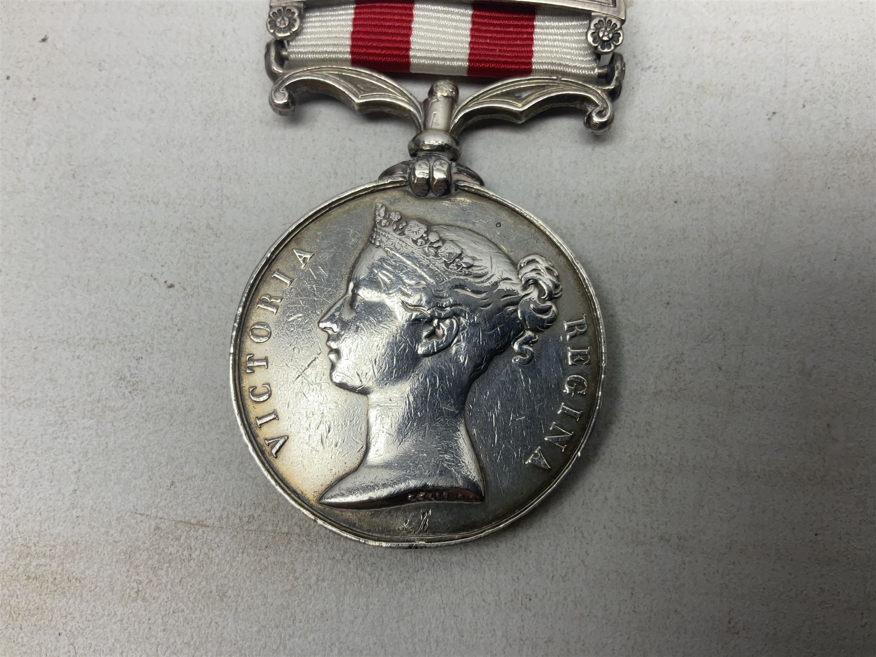 Victoria India Mutiny Medal 1857 - 1858, name erased, with Lucknow clasp and ribbon