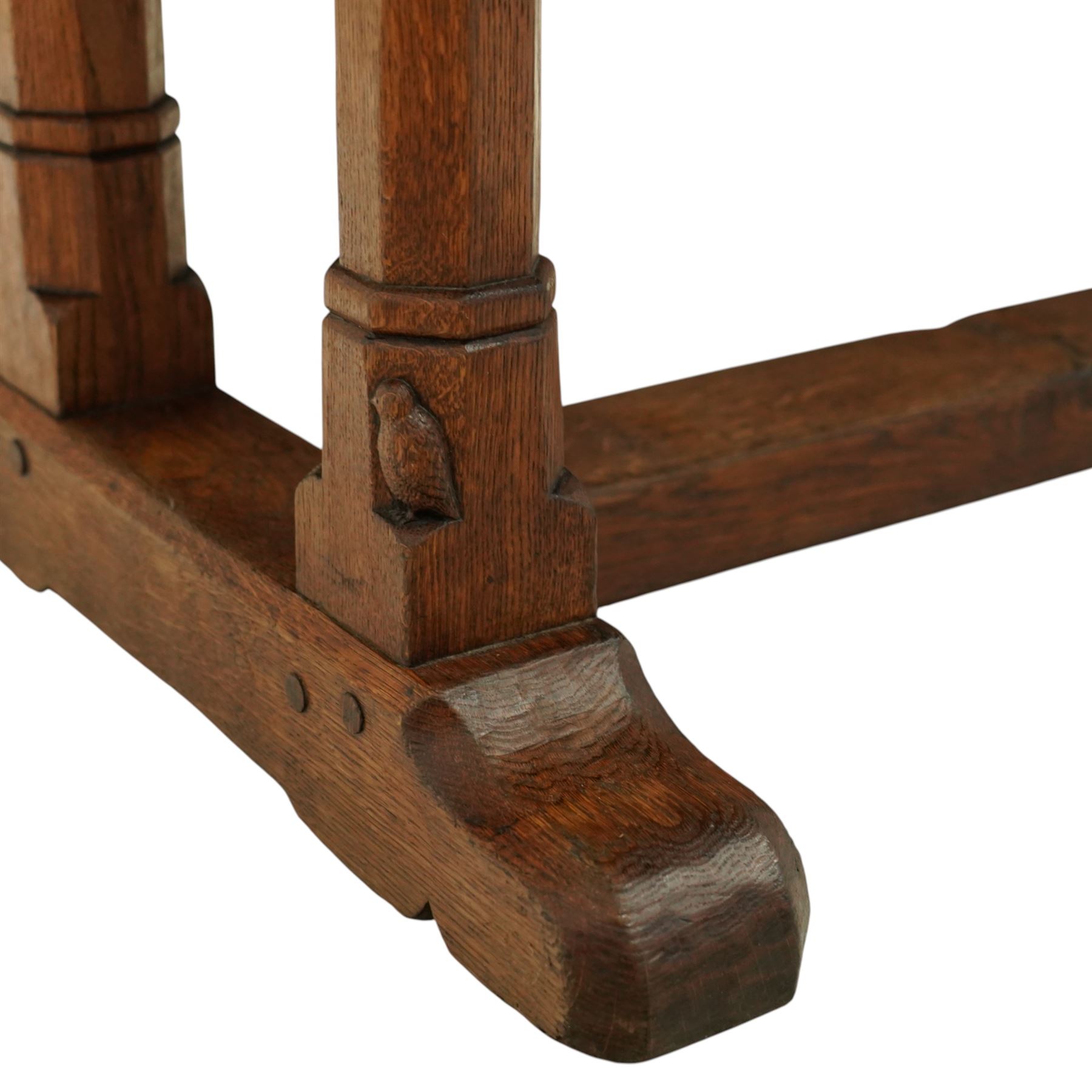 Mouseman - 1937 refectory table, Sir Herbert Baker commission for Westminster Church House, the rectangular adzed plank top above twin octagonal baluster supports united by a pegged stretcher, raised on shaped sled bases carved with a partridge and a loaf of bread, with carved mouse signature to inside leg, by Robert Thompson of Kilburn

The carved loaves reference the original patron, while the partridges are thought to represent Frank Partridge, Bishop of Portsmouth from 1877 to 1941, who played a key role in the founding of Church House and served as its Secretary from 1936 until 1941

Reference
Christie’s ROBERT “MOUSEMAN” THOMPSON; Refectory Table, Lot 188, sold at Christie’s London, commissioned by Sir Herbert Baker KCIE, RA, architect of Church House (opened 1937). Provenance and description available on the Christie’s website
https://www.christies.com/en/lot/lot-4618786