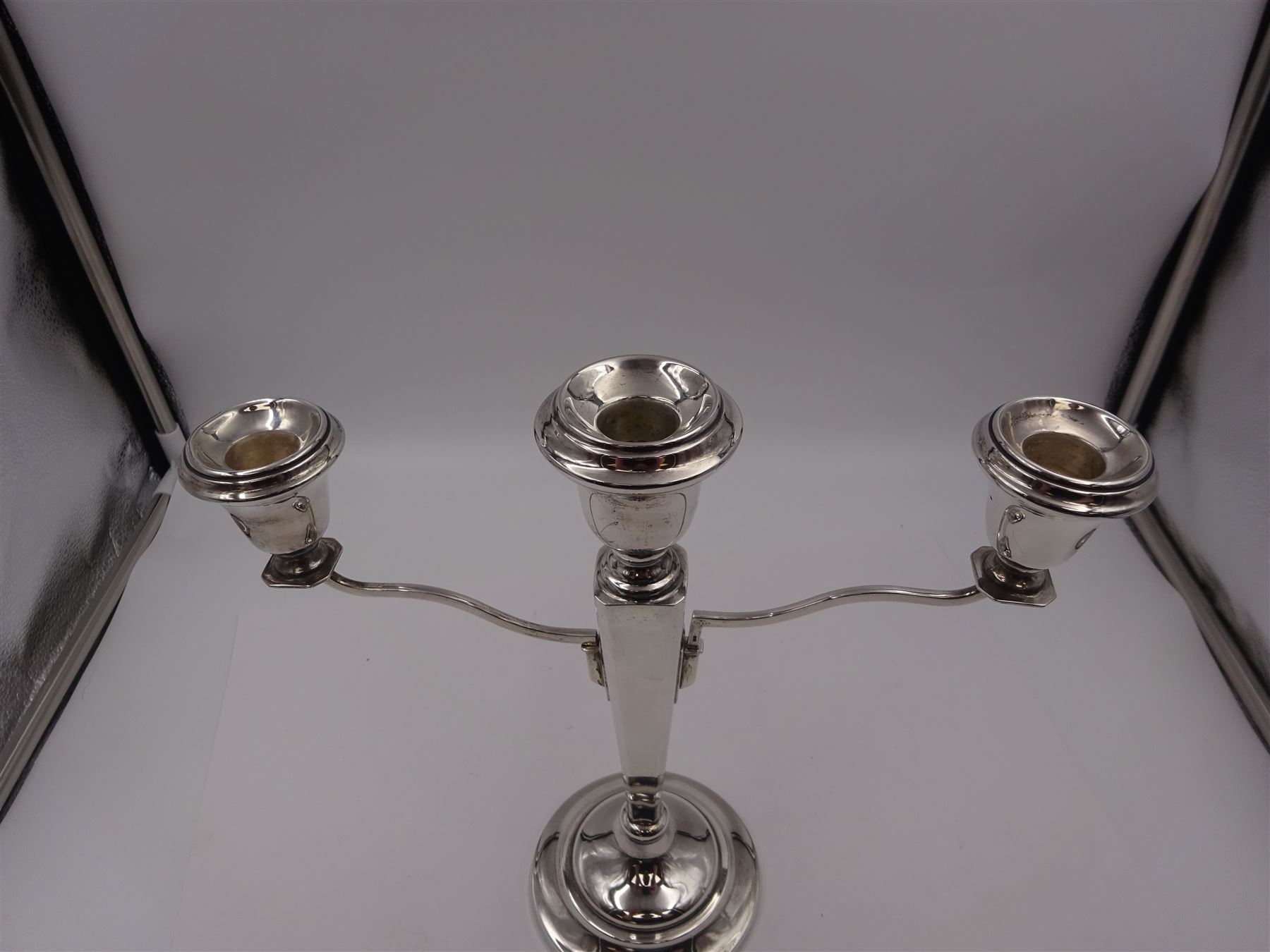 Modern silver mounted three branch candelabra, the tapering stem supporting a central candle holder and two removable curved branches with candle holders, upon spreading circular foot, hallmarked Birmingham 1968, maker's mark worn and indistinct, H25.5cm