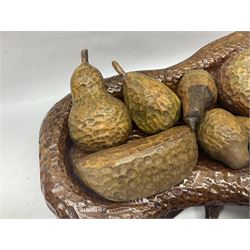 Helen Skelton (British 1933 – 2023): Carved wooden abstract sculpture, modelled as a fruit bowl with a adzed finish, with eight pieces of carved fruit, bowl W33cm, L52cm. Born into an RAF family in 1933 in Kent and travelled the world extensively during her childhood. After settling in Bridlington, Helen immersed herself in painting, textiles, and wood sculpture, often inspired by nature's beauty. Her talent was showcased in a one-woman show at Sewerby Hall and recognised with the sculpture prize at Ferens Art Gallery in 2000. Sadly, Helen’s daughter passed away from cancer in 2005. This loss inspired Helen to donate her sculptures to Marie Curie upon her passing in 2023.