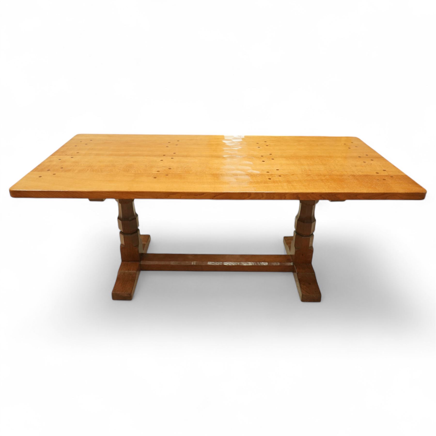Mouseman - adzed oak 6’ refectory dining table, rectangular top with visible dowel pegs and adzed surface, raised on octagonal carved supports with stretcher and sledge feet, carved mouse signature to leg, by the workshop of Robert Thompson, Kilburn
