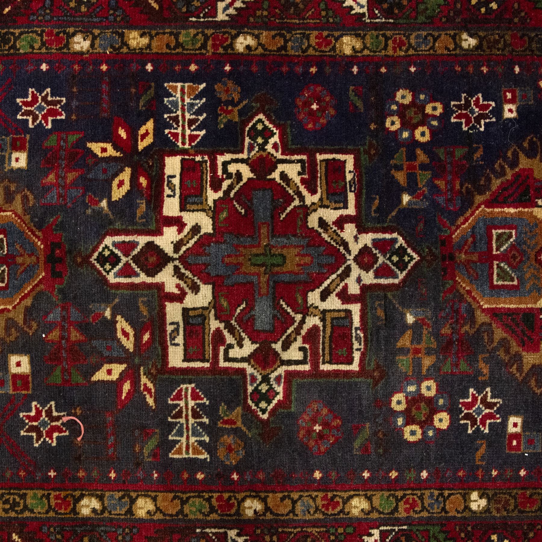 Large Northwestern Persian Hamadan hand-knotted runner, indigo field, with a column of bold geometric medallions and scattered stylized motifs within a madder border of angular rosettes and meandering vines 