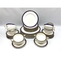 Paragon dinner wares, decorated with gilt scrolls and blue band, in one box 