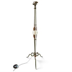 Arts and Crafts wrought iron and copper standard lamp, the openwork stem centred by a cut-glass reservoir with arrow-cut decoration, applied with stylised copper leaves, on shaped tripod base