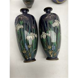 Pair of Japanese Meiji period cloisonné vases of slender ovoid form decorated with iris flowers in purple and white on deep blue ground,  together with four cloisonné bowls decorated with dragons and flowers with enamelled blue interiors, and further miniature vase, tallest H20cm
