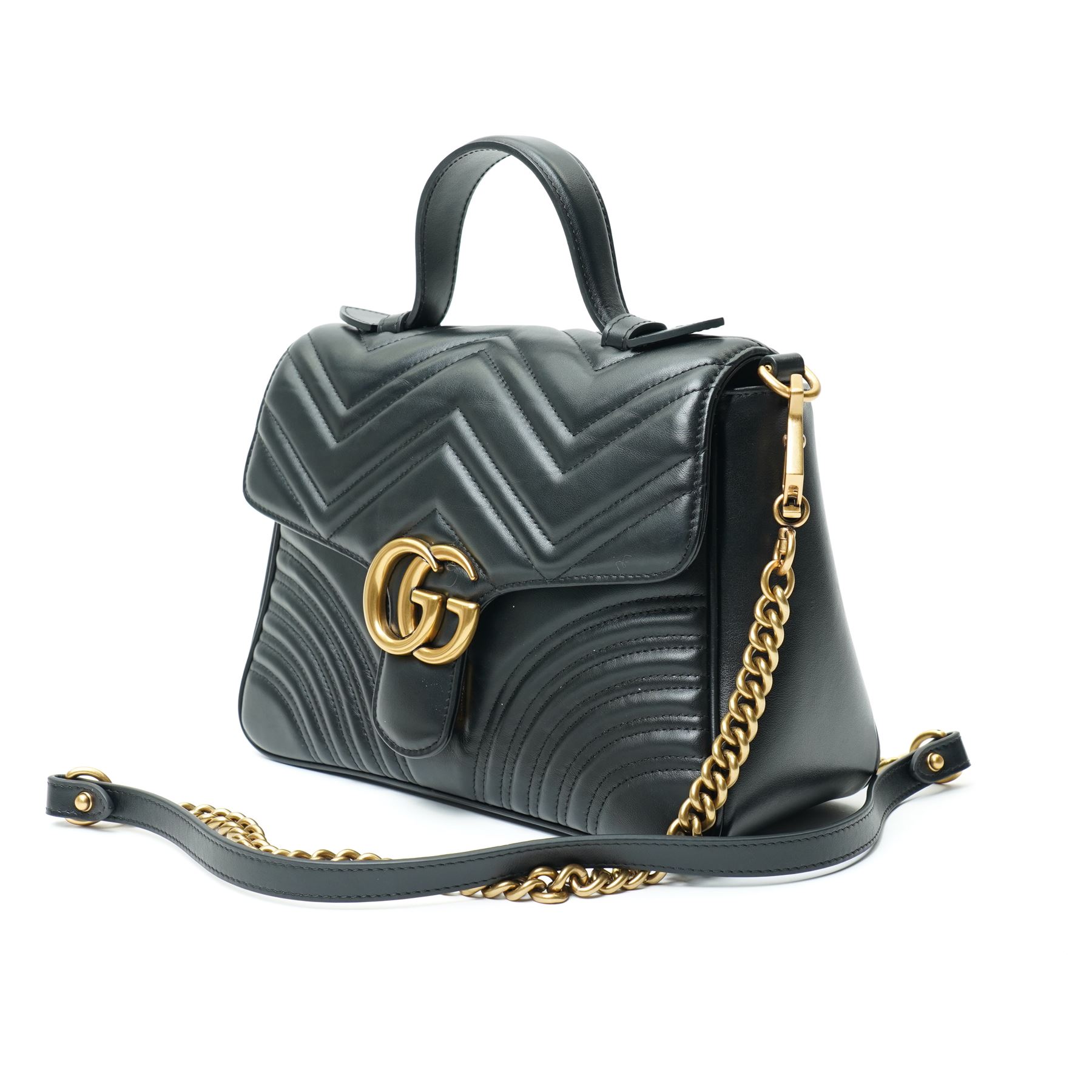 Gucci GG Marmont black matelassé leather top handle bag, made in Italy, with chevron quilted leather and heart motif to the reverse, antique gold-tone Double G front hardware, leather top handle and detachable chain shoulder strap with leather shoulder guard, front flap closure, suede-effect interior with zip pocket and leather logo tab stamped Gucci made in Italy, together with original Gucci dust bag and carrier, W27cm D11cm H20cm