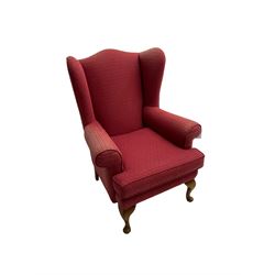 Queen Anne design wingback armchair, upholstered in lozenge patterned crimson fabric, raised on cabriole front supports