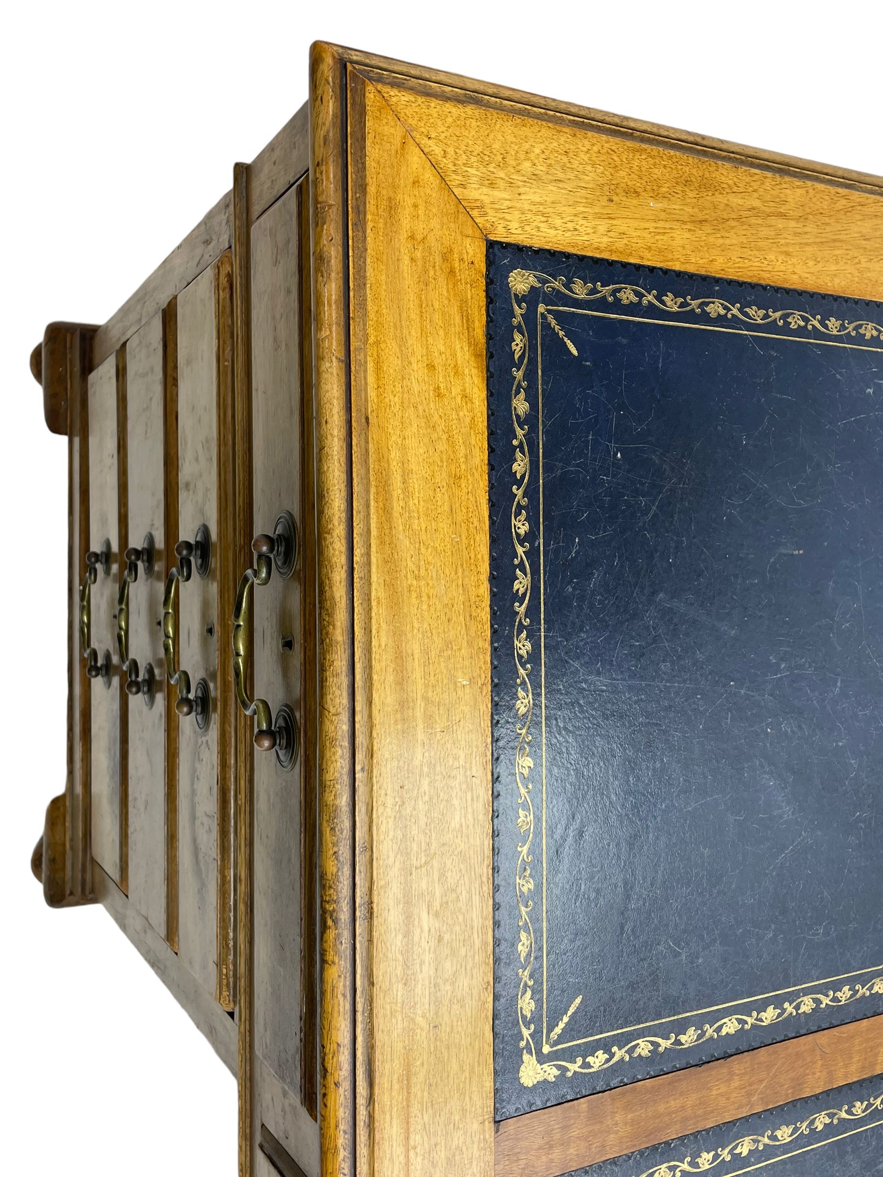 Early 20th century mahogany twin pedestal desk, the moulded rectangular top with three sectional leather insets with gilt decoration, fitted with eight drawers, on cabriole feet