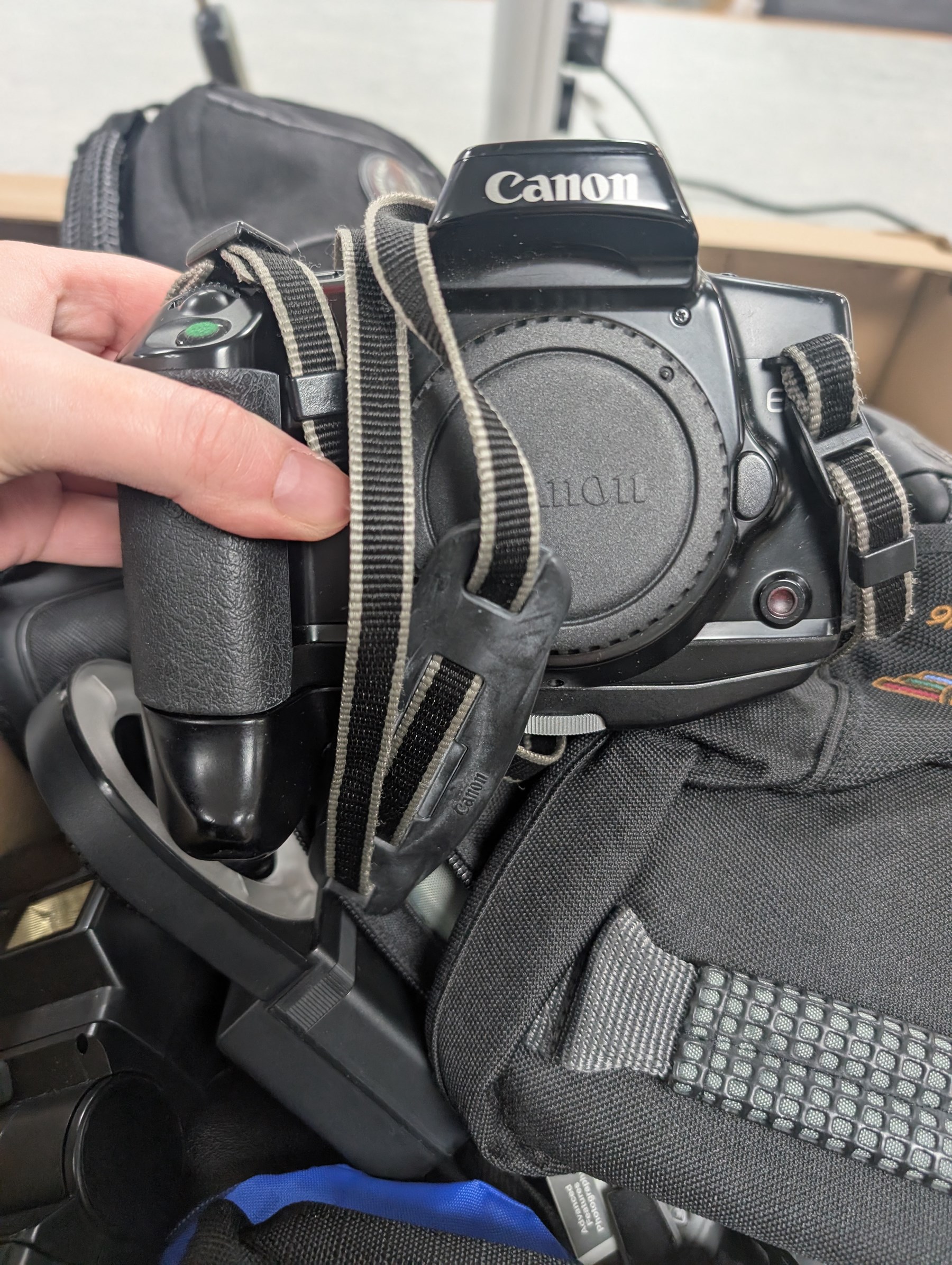 Collection of cameras and photography equipment, including Canon EOS 1000F DSLR, Fujifilm S9500, Canon EOS 10, lenses, filters, tripods, etc, in three boxes