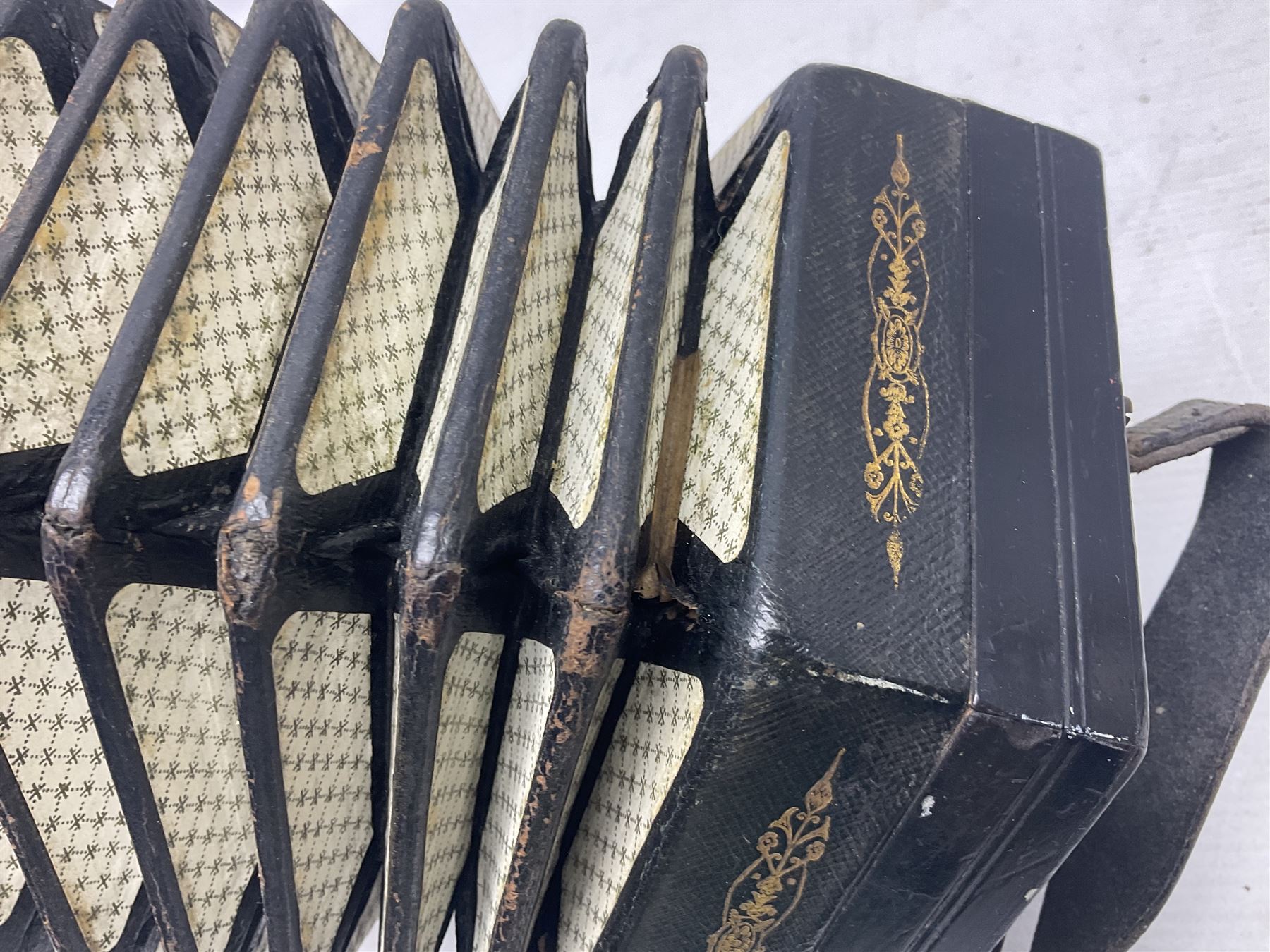 19th century Lachenal concertina of hexagonal form with fretworked nickel ends and thirty-four plus one bone buttons; straps marked Lachenal & Co Makers London and wooden handle stamped English Make Trade Mark L16cm