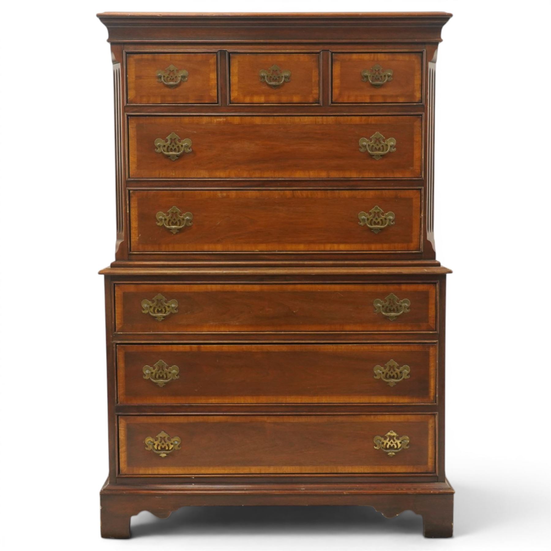 Georgian design mahogany chest on chest, moulded projecting cornice over three short and two long drawers, canted fluted front corners, lower section fitted with three long drawers, brass pierced backplate handles and escutcheons, on shaped bracket feet