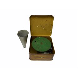 Gebruder Bing Germany Pigmyphone child's portable toy gramophone in woodgrain finish tin-plate box with key and tin of needles L15cm; and nine small records of nursery rhymes; together with a Japanese tin-pate 'Skip Rope Animals' clockwork toy, boxed.