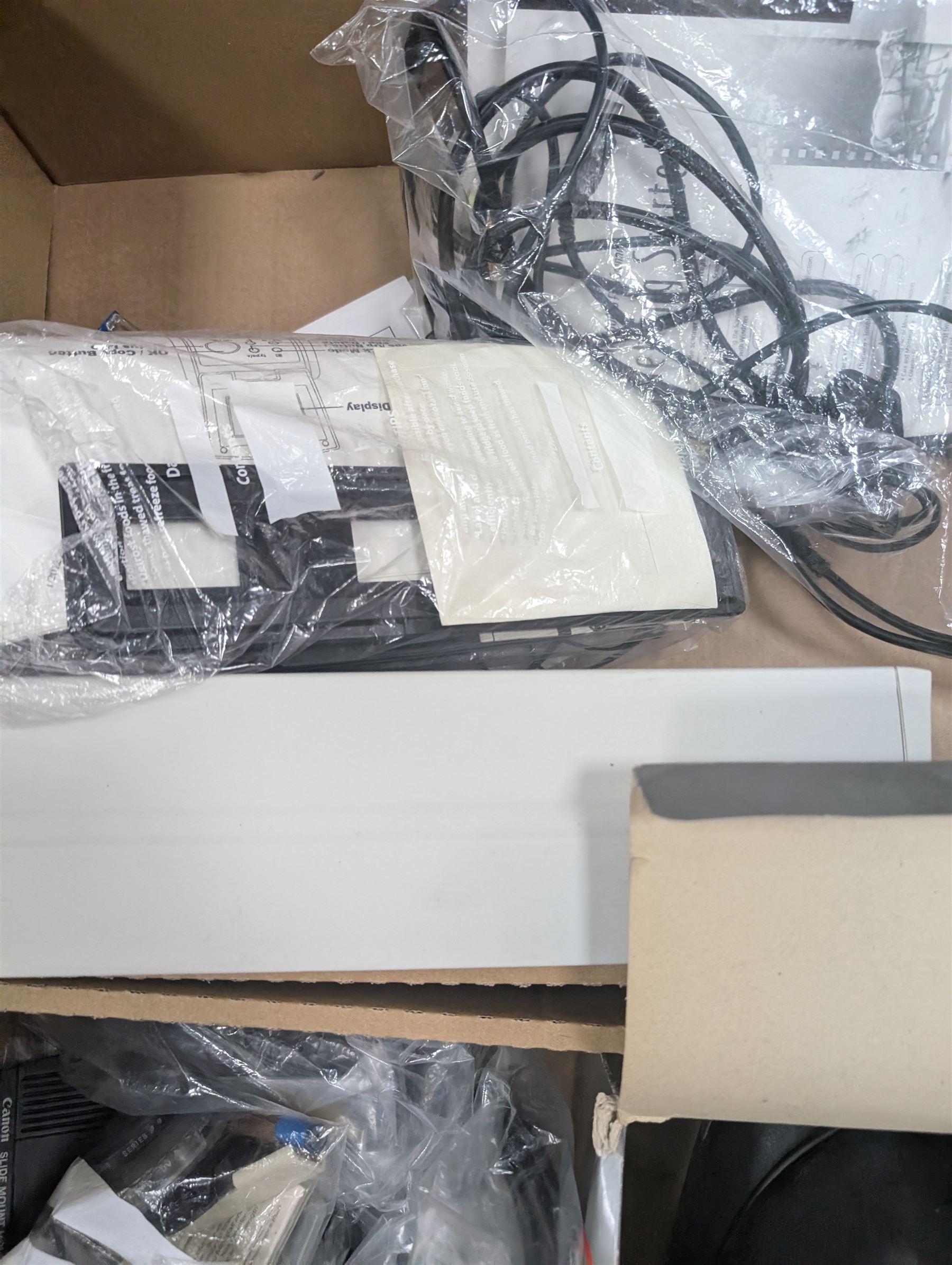 Collection of predominantly Canon camera accessories, including CanonScan FS40000US, cases, straps, cables, etc 