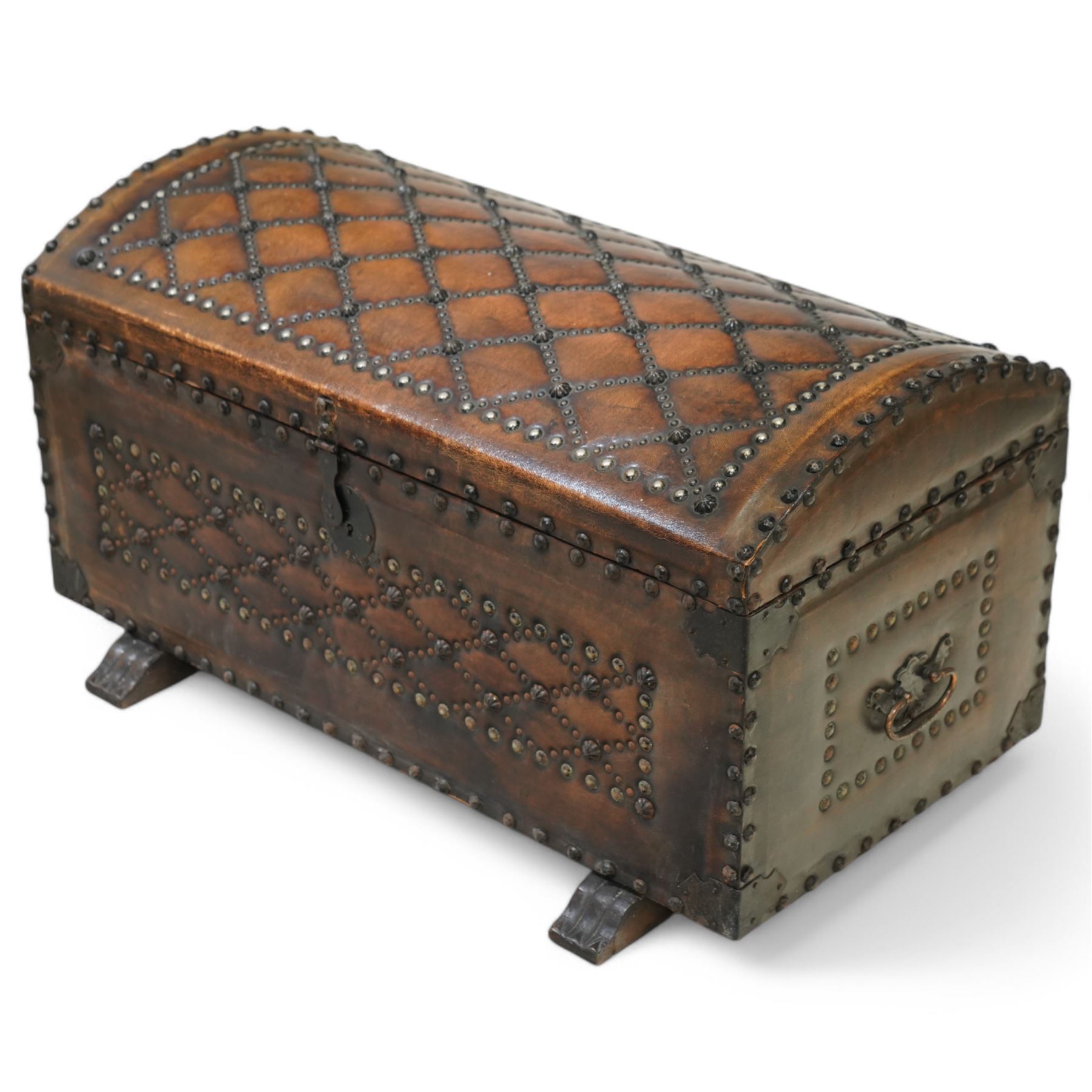 Studded leather dome top trunk, the hinged lid and front decorated with cross pattern in studs, on sledge feet 