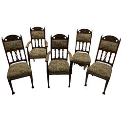 Set five early 20th century Arts & Crafts style oak dining chairs, the cresting rails carved with green man mask, cushioned back over shaped pierced splats, two carvers and three side chair 