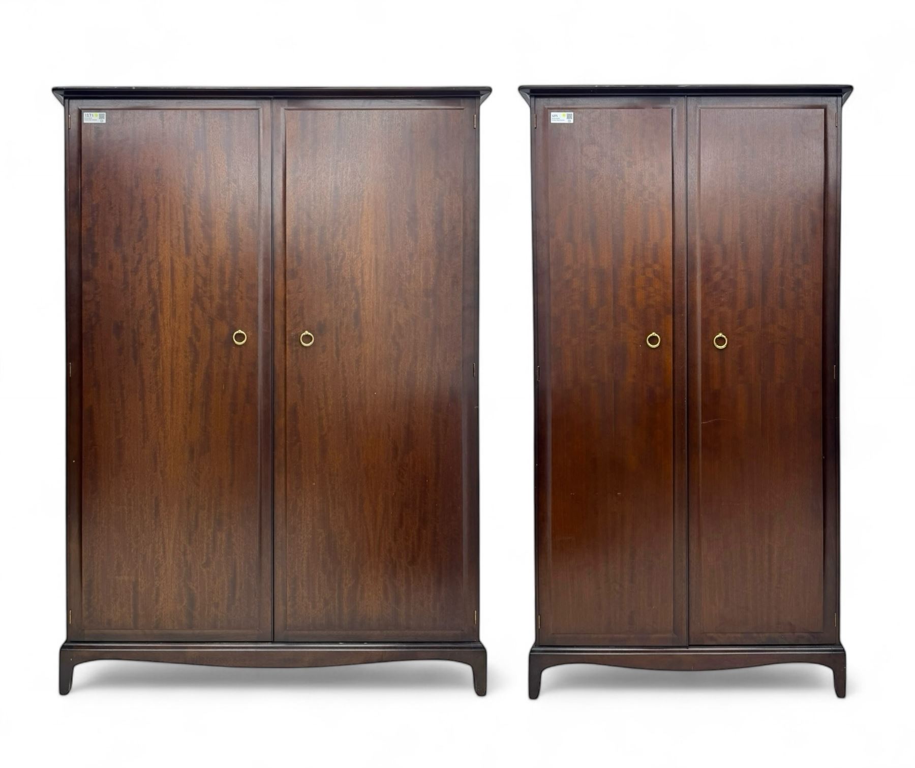 Stag Minstrel - pair of mahogany double wardrobes, comprising a larger wardrobe with a shelf and hanging rail behind two panelled doors (W127cm, D59cm, H177cm); and a smaller wardrobe enclosing a single hanging rail (W96cm, D59cm, H177cm), both finished with projecting cornices and raised on bracket feet



