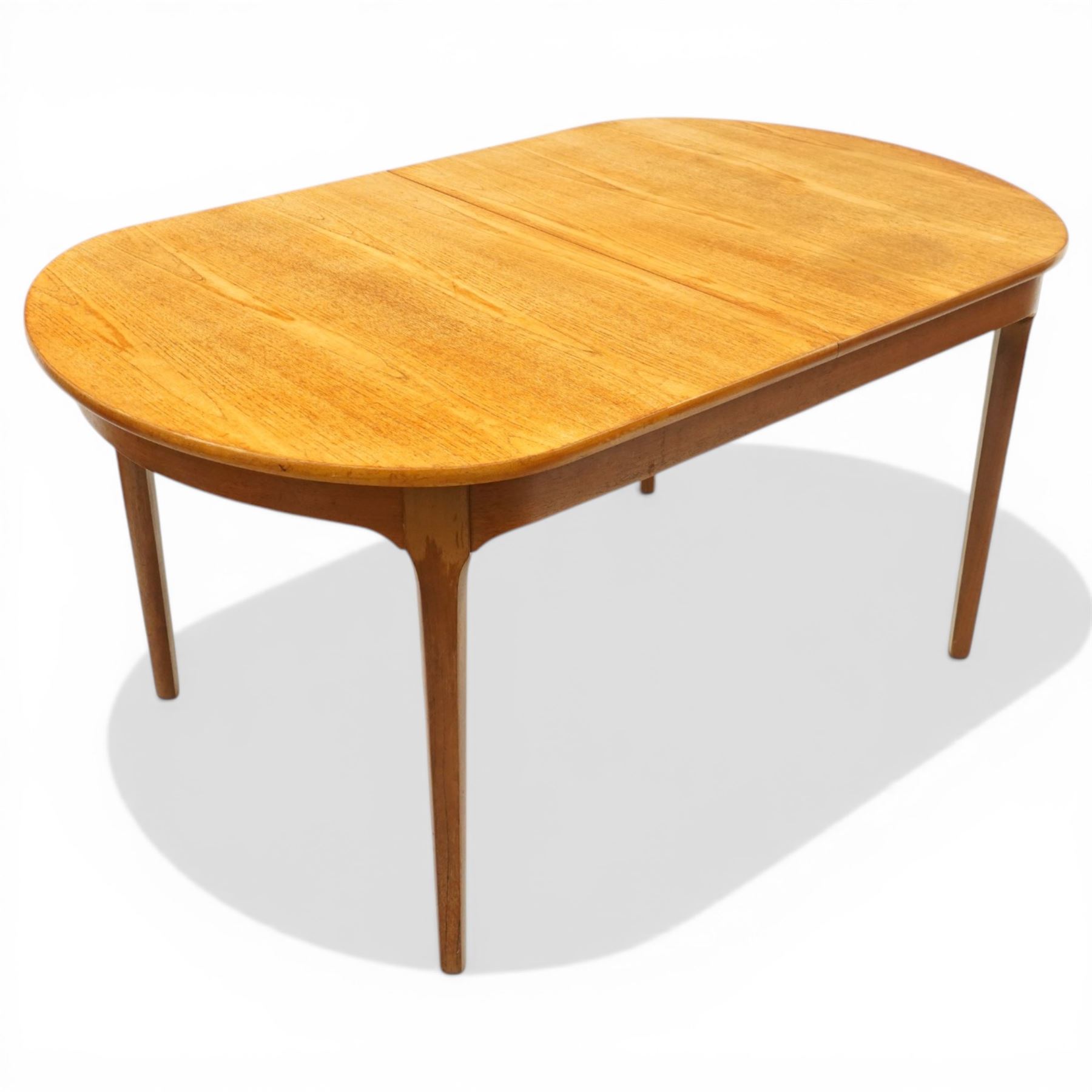 Nathan - teak oval extending dining table, together with set of eight matching low-back dining chairs with tan leather seats, extends to 203cm