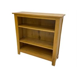 Light oak open bookcase, fitted with two adjustable shelves
