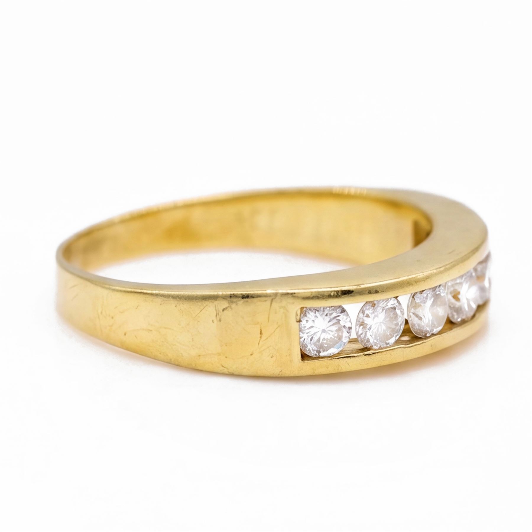 18ct gold diamond ring, channel set with seven round brilliant cut diamonds, hallmarked, total diamond weight 0.75 carat