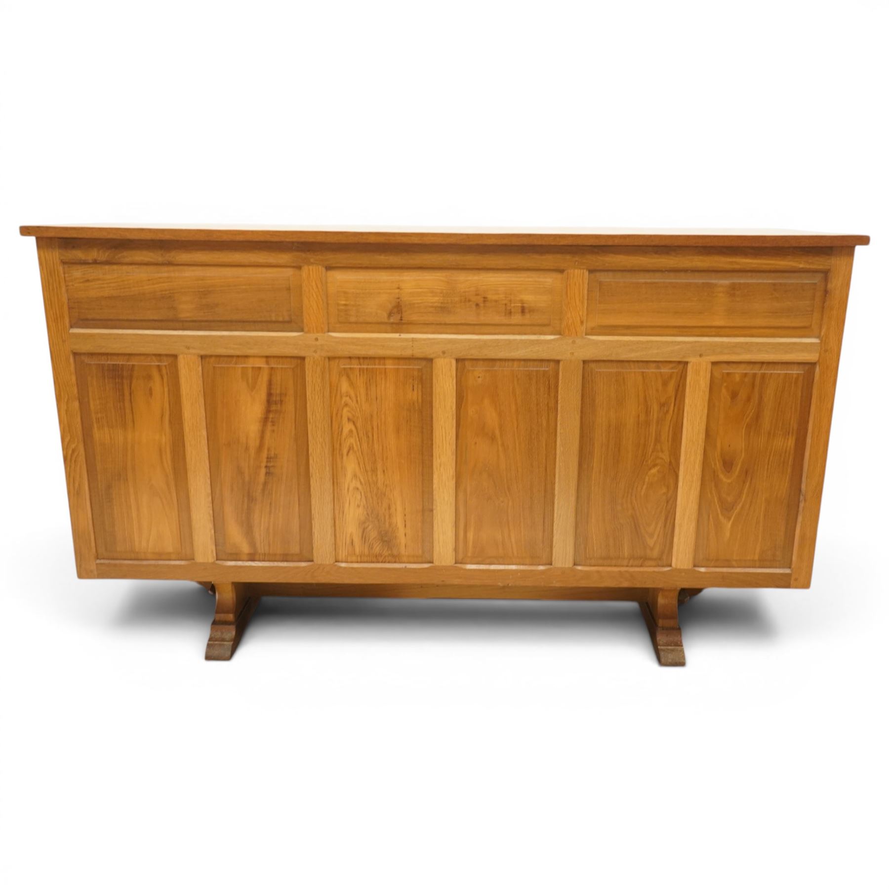 Beaverman - 1980s adzed oak sideboard raised on a trestle base, three drawers over three cupboards with Yorkshire Rose carved handles, fielded panelled sides and front, with carved Beaver, by Colin Almack of Sutton near Thirsk