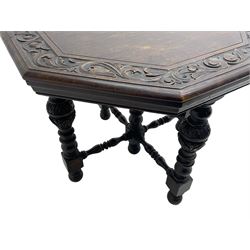 Late Victorian carved oak centre table, octagonal moulded top with carved scrolling foliage band, on five turned and foliate carved pillar supports joined by turned x-framed stretchers, on turned feet