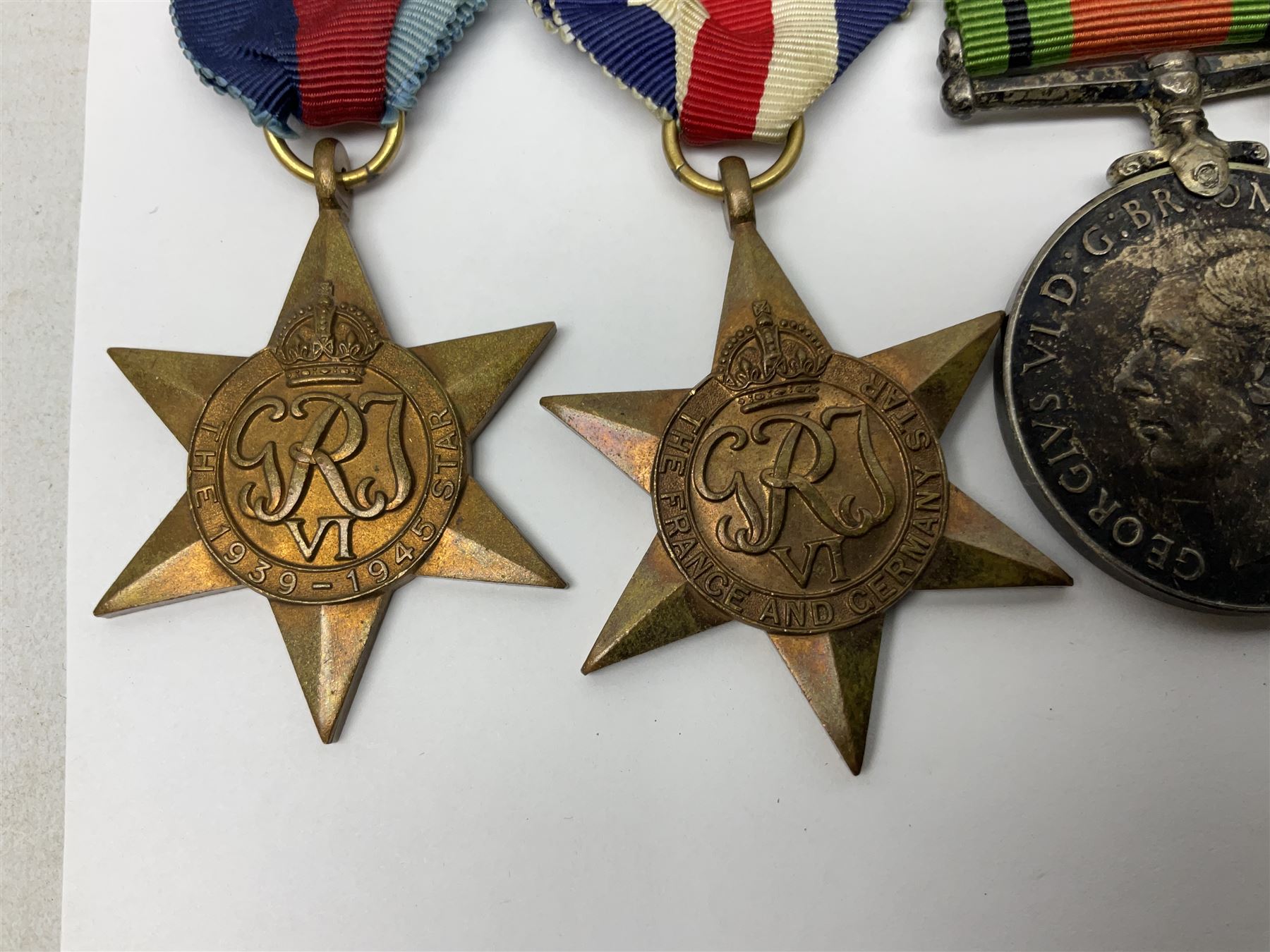WW2 group of five medals comprising 1939-1945 War Medal, Defence Medal, 1939-1945 Star, France and Germany Star and Canadian Volunteer Service Medal; on wearing bar with ribbons; with a medal box and slip and three photographs