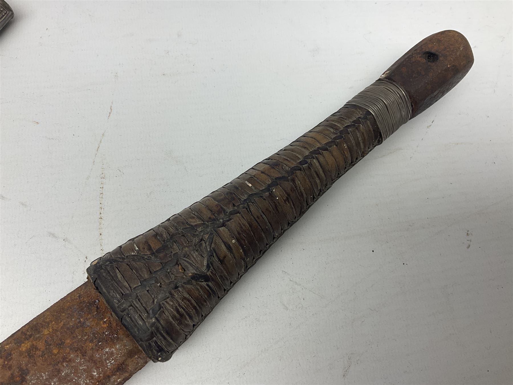Omani presentation sword kattara, with 77cm  broad slightly curved single edge blade with two fullers, leather bound hilt woven with silver wire decoration and iron pommel;  in tooled leather scabbard with chased silver mounts and presentation plaque 'To Capt. D.M. Naylor From C Company NFR Oman Dec 1962' (Northern Frontier Regiment) L99cm overall