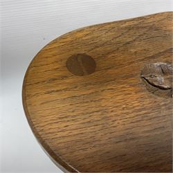 Wrenman - three-legged oak milking stool, kidney-shaped top carved with wren signature, on three splayed turned supports, by Bob Hunter, Thirlby, Thirsk
