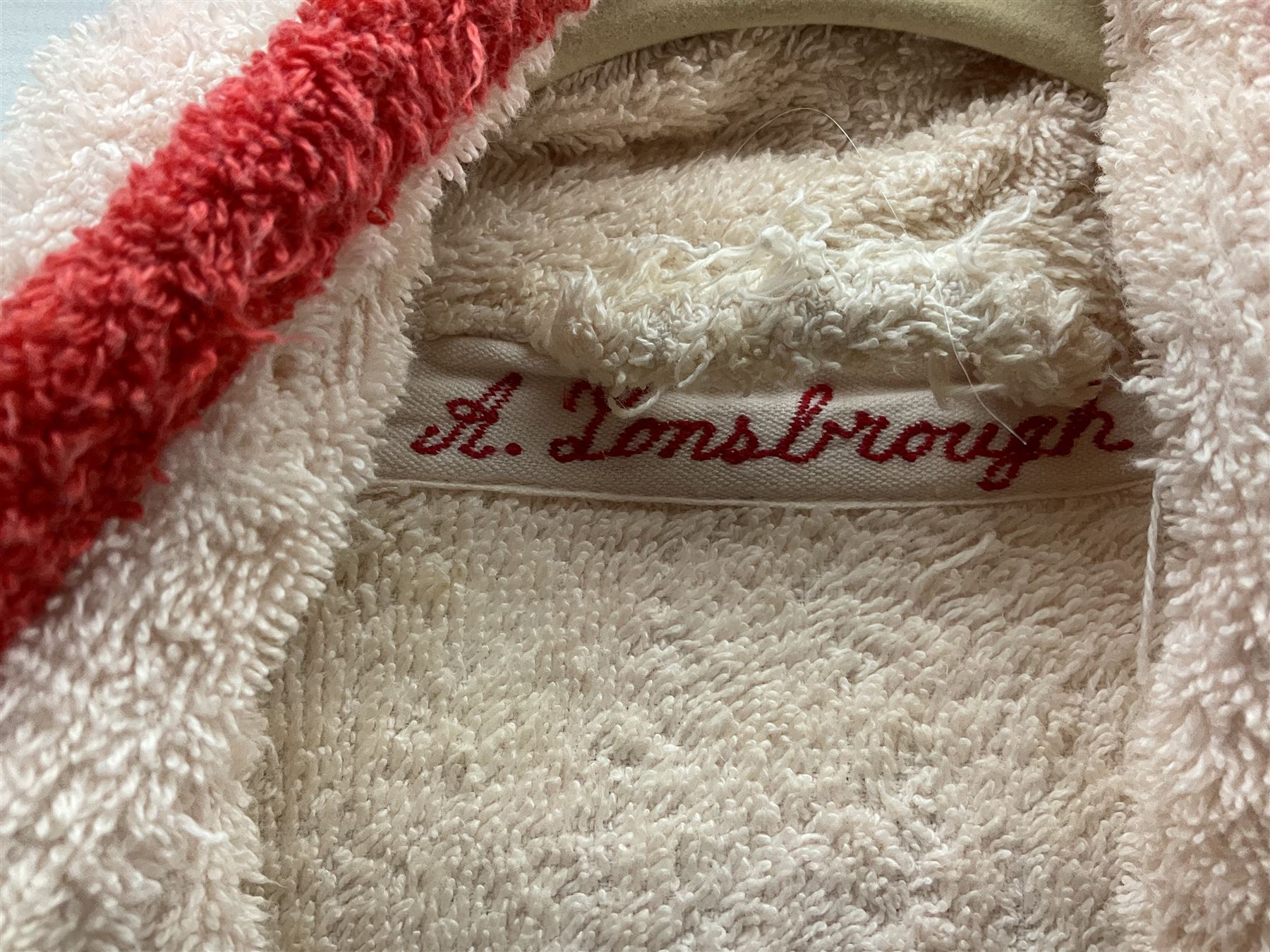 On the direct instructions of Anita Porter nee Lonsbrough Great British Olympic and Commonwealth Games gold medal winning swimmer - collection of early and international memorabilia comprising original Huddersfield Bath Club track suit top bearing eight stitched on cloth badges including British Empire & Commonwealth Games 1958 England Team, YSASA, North Eastern Counties ASA, ESSA Division 3,  English Schools Swimming Association winner etc
The swimming costume Anita wore at the 1958 Commonwealth Games in Cardiff, her first major championships, where she won two gold medals. The grey elastic on the sides, in those days, she would use to make it tighter and more streamlined.
Blue track suit from the 1960 Olympics which she wore on the podium receiving the gold medal.
1960 pool side towelling robe used at the Rome Olympics (interesting to note her name is spelt wrong on the embroidered label).
1962 Commonwealth Games pool side towelling robe used in Perth Australia when winning three Gold medals. 
It was also this year she became BBC Sports Personality of the year, the first female to do so.
Her 'lucky' pool side towel which she took with her to every event she competed in and which can be seen round her neck in many official celebratory photographs. Copies of some of these photographs are included for identification.
In addition there are two souvenir programmes of an evening event to honour Anita at The Theatre Royal Huddersfield and she has kindly signed the front cover on one of these.