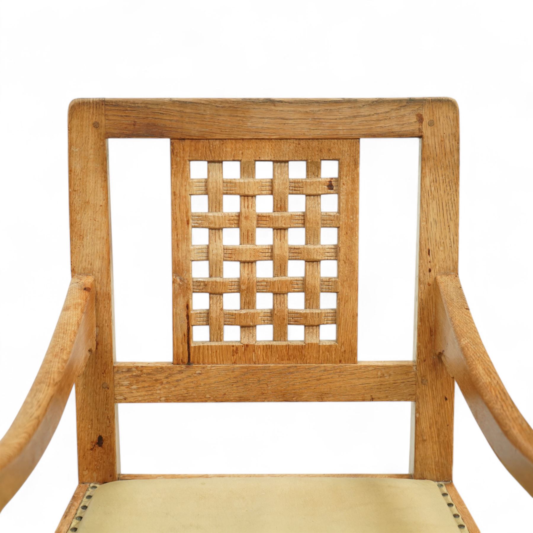 Mouseman - set of eight (7 + 1) oak dining chairs, pierced and carved lattice back over leather upholstered seat, on octagonal front supports united by stretchers, carved with mouse signature, by the workshop of Robert Thompson, Kilburn