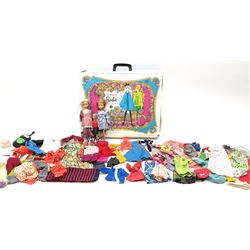The World of Barbie Double Doll Case containing a quantity of assorted doll's clothing; together with two large and one small fashion dolls.