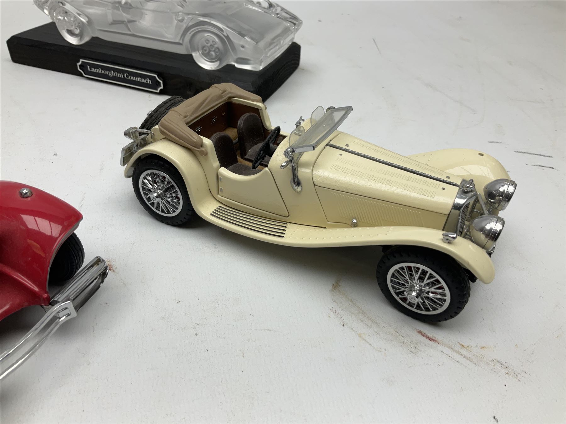 Three Franklin Mint die-cast models comprising 1935 Mercedes 500k Special Roadster, 1938 Jaguar SS-100 and 1907 Rolls Royce The Silver Ghost, together with Hof Bauer glass Lamborghini Countach
model and Bburago Jaguar 1961 'E' type