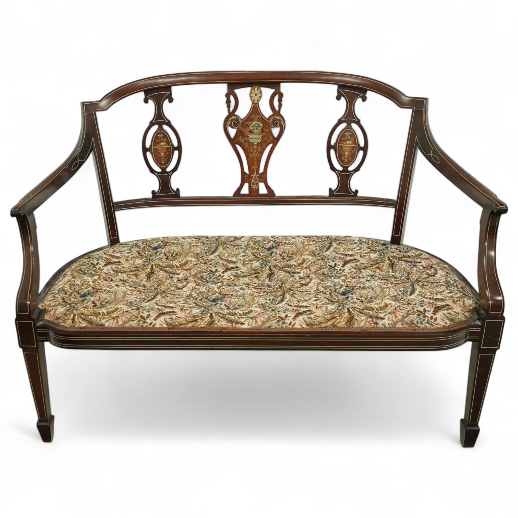 Edwardian marquetry inlaid mahogany salon settee, with bowed top rail and pierced splat back featuring central classical urn flanked by oval floral medallions, floral upholstered seat on boxwood strung square tapering legs terminating in spade feet