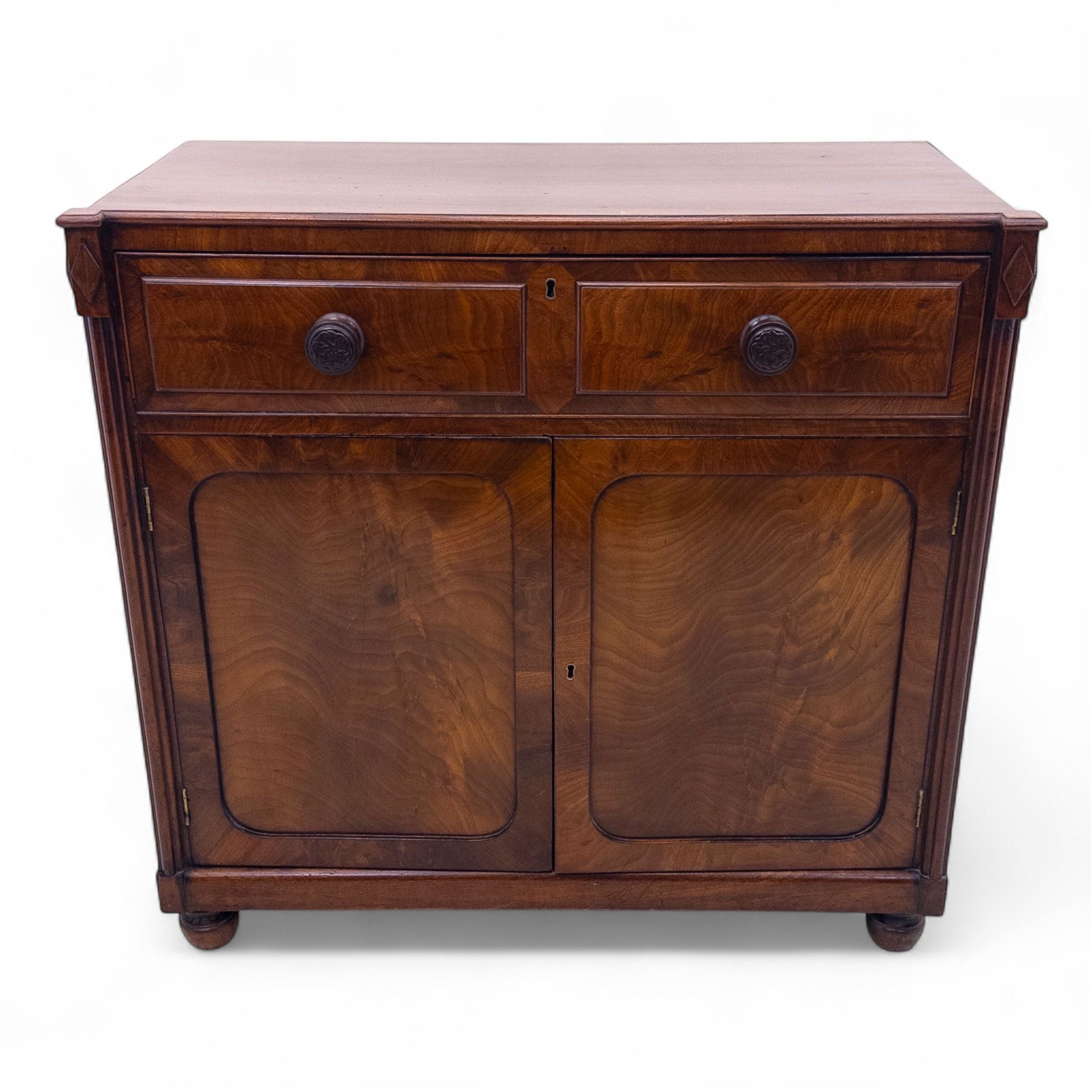 Regency mahogany secretaire cabinet, rectangular top over fitted secretaire drawer enclosing a tooled leather writing surface and pigeonholes, above a pair of panelled cupboard doors, raised on bracket feet