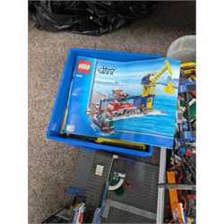 Large collection of Lego, including partially built vehicles, Police Station, Lego Creator 31010 and a collection of Lego instruction booklets