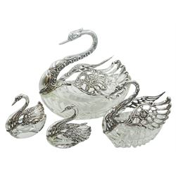 Four cut glass and silver mounted bonbon and salt dishes modelled as swans with pierced and articulated wings, three stamped stamped 835 Silver, one smaller  stamped 925 beneath, also bearing import marks for London Assay Office, date letter indistinct, largest example H15cm