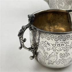 Late Victorian silver bachelors three piece tea service, comprising bullet shaped teapot, open sucrier and milk jug, each engraved with monogram surrounded by birds upon and amidst a blossoming vine, the teapot with scroll capped curved wooden handle and wooden finial to cover, hallmarked Wakely & Wheeler, London 1890, teapot including handle H12cm, sucrier H5.5cm 