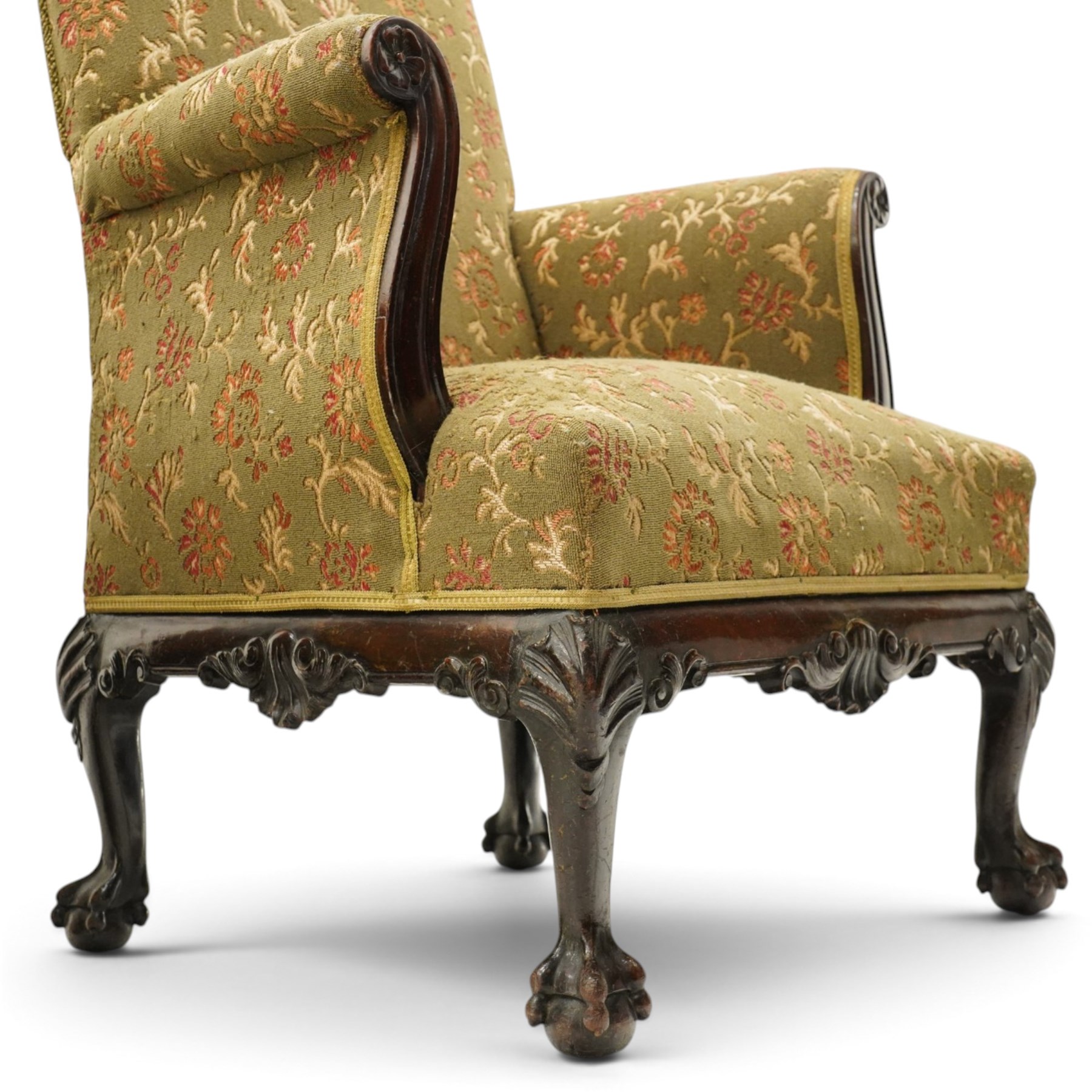 Pair of Chippendale design carved mahogany framed armchairs of stylised lyre form, high square backs and sprung seat upholstered in olive-ground foliate fabric, scrolled arm terminals with applied rosettes, the seat rail moulded with central scallop-and-acanthus motif, raised on shell-carved cabriole supports with ball-and-claw feet