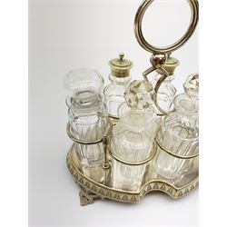 A silver plated and glass six piece cruet/condiment set, the stand with shaped feet and carry handle, H23cm. 