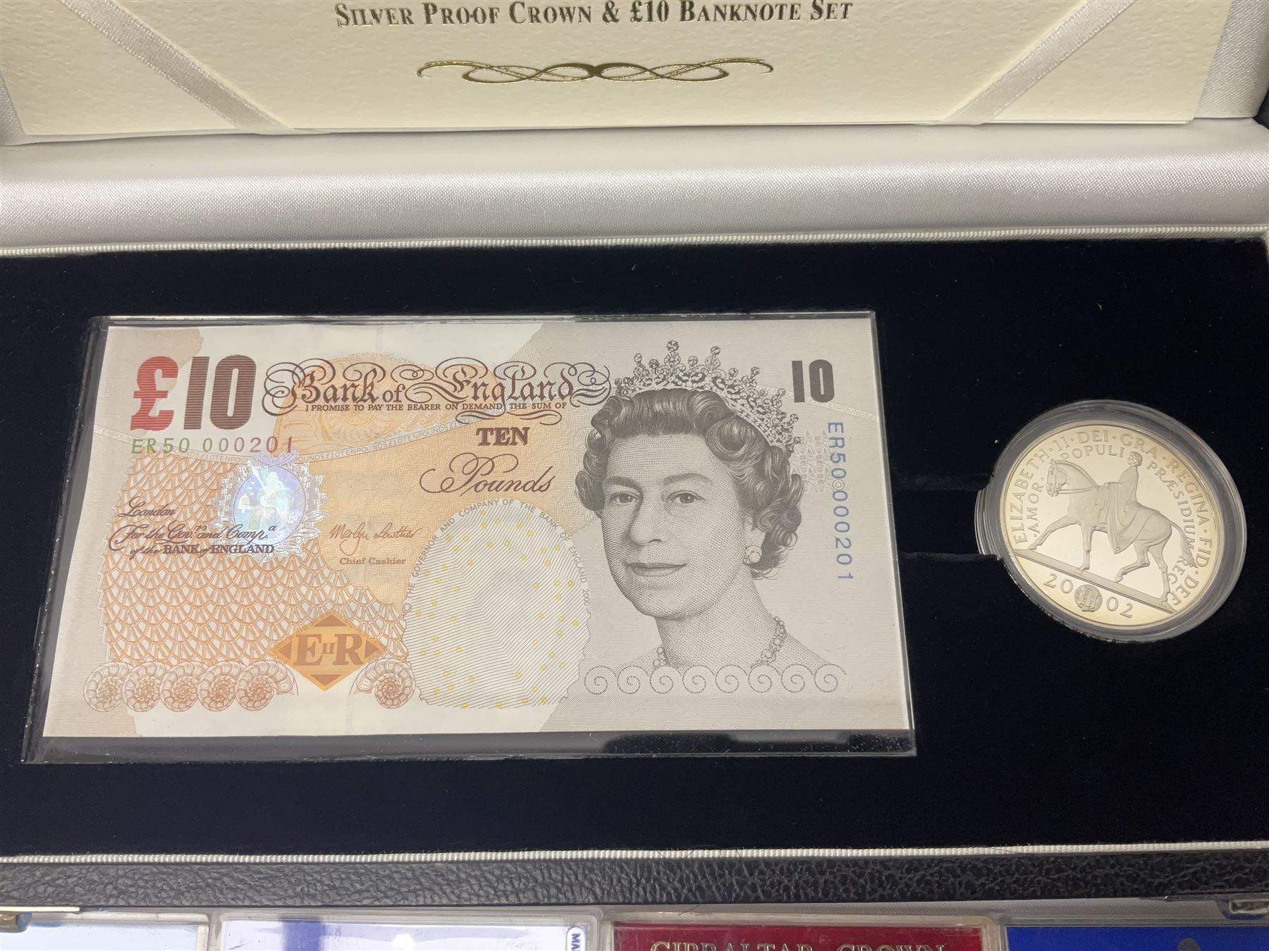 The Royal Mint United Kingdom 'Millennium' silver proof two coin set comprising 1999 and 2000 five pound coins, 2000 'The Queen Mother Centenary Year' silver proof crown, 2001silver proof one pound, 'Her Majesty The Queen Golden Jubilee 1952-2002' silver proof 2002 five pound coin and ten pound banknote set, all being cased with certificates, United Kingdom 1999 brilliant uncirculated coin collection in card folder, other commemorative coinage etc