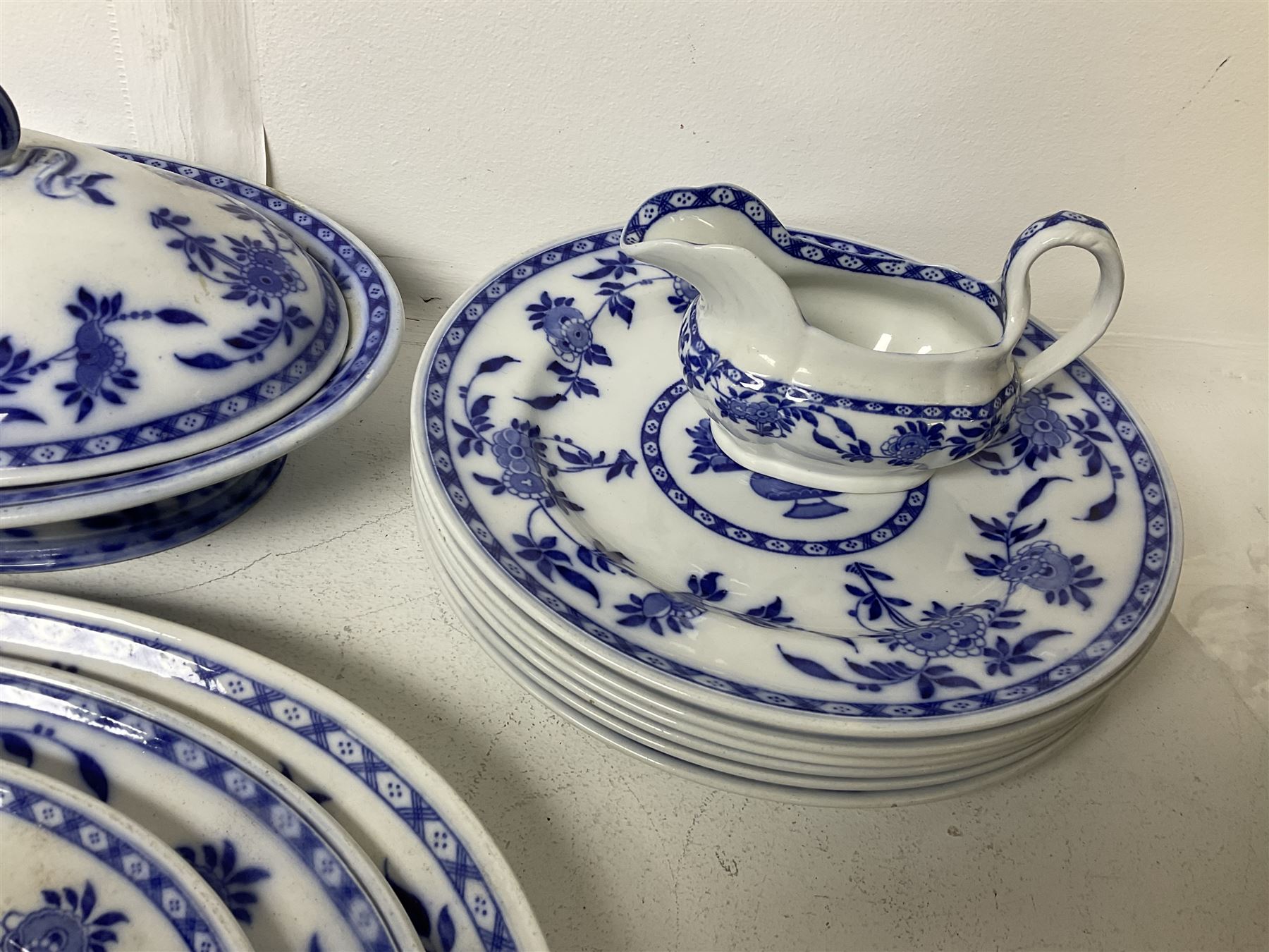 Mintons Delft blue and white dinner wares, to include three graduating oval platters, six dinner plates, six dessert plates and six side plates, tureen with cover and two sauce boats