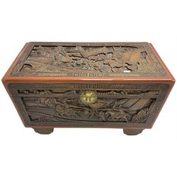 Mid-20th century Singapore camphor wood blanket chest, heavily carved depicting battle scenes and cityscapes 