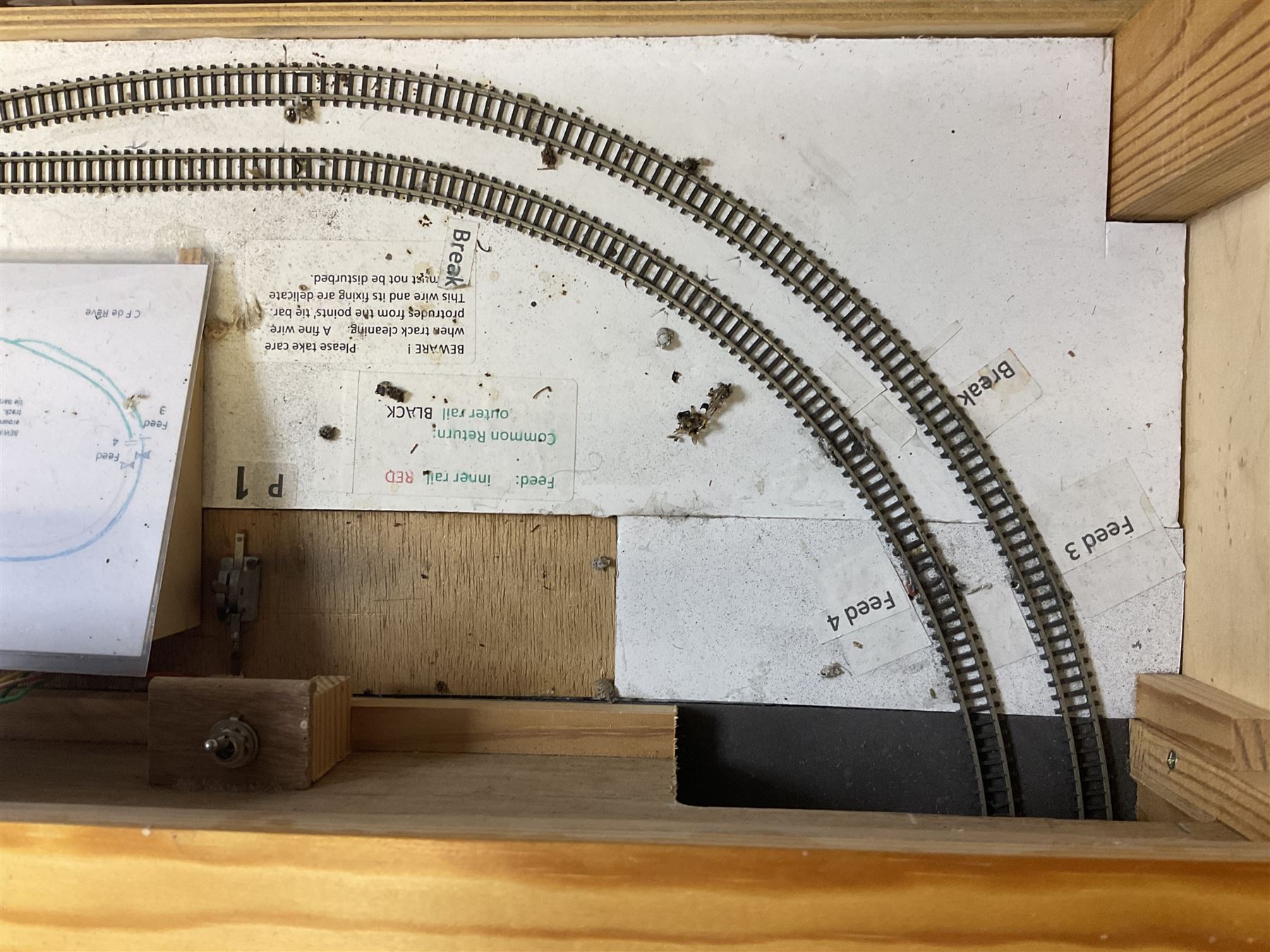 'Z' gauge continental scenic layout with folding legs, various loops of track and sidings with overhead cables, buildings including water tower, tunnels, roads with motor vehicles and figures, trees, haven with boats, backdrop diving wall hiding control units 150 x 50cm