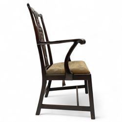 19th-century Chippendale Revival design mahogany oversized high-back armchair, serpentine crest carved top rail above pierced back splat with interlaced ribbon carving and geometric fretwork design, and outward scrolling arms above drop-in needlework seat on square chamfered legs 