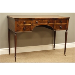  19th century Gillows style mahogany dressing table, rectangular inverted bow break front top with figured banding, curved drawer and four small drawers, knee hole apron, on four slender reeded supports with brass cups and castors, W112cm, H78cm, D50cm  