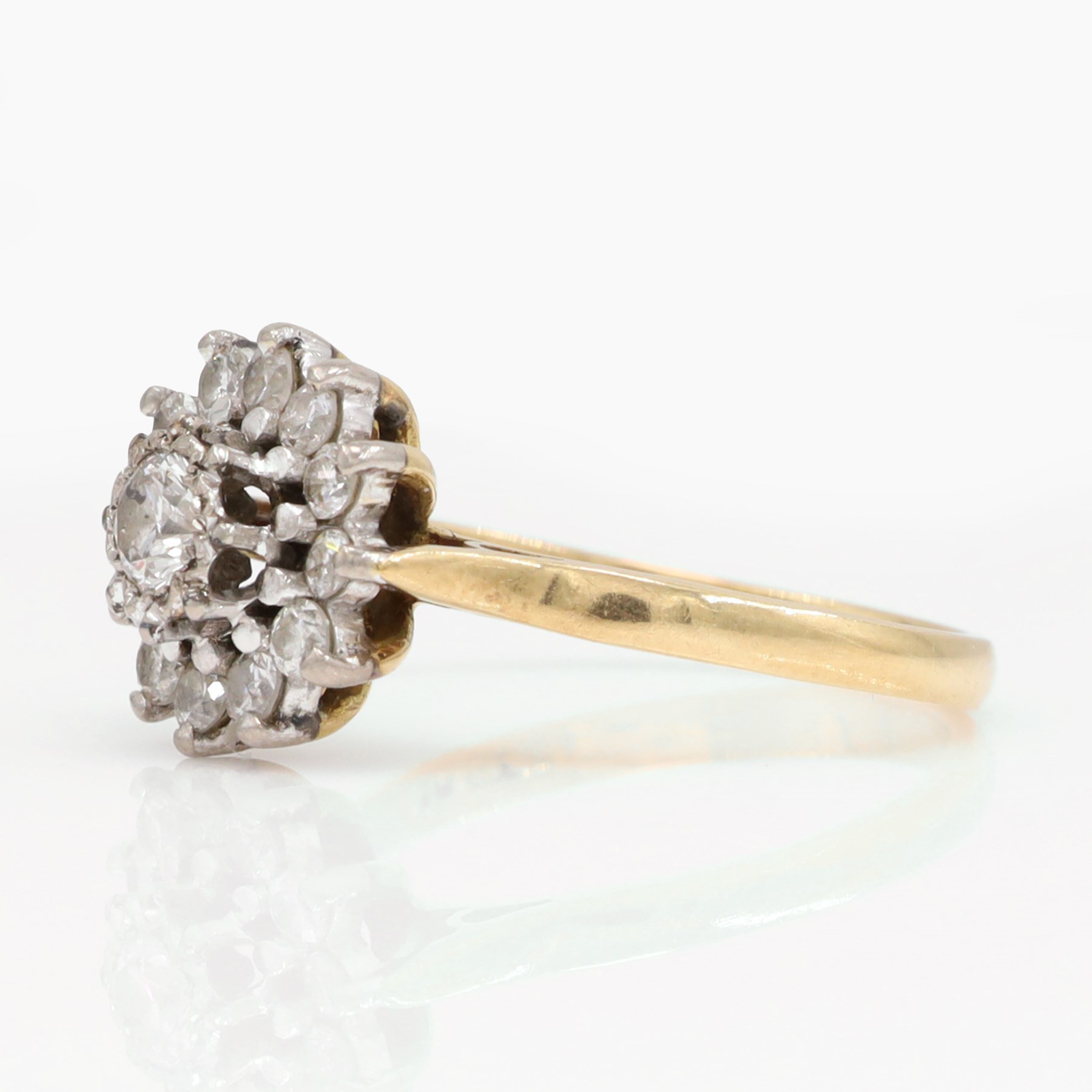 Gold diamond flower head cluster ring, single round brilliant cut diamond, surrounded by twelve further diamonds, stamped 18ct