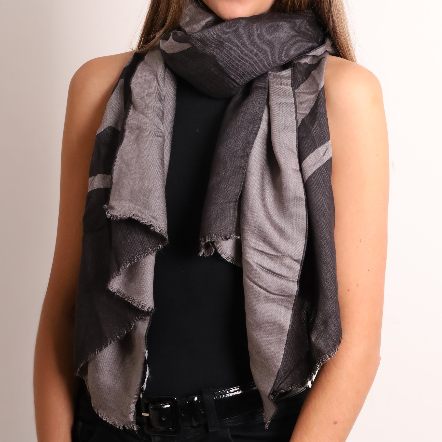 Mulberry - three scarves, comprising grey scarf with repeating tree motif, tan, cream and grey check scarf, and charcoal grey scarf with oversized ‘Mulberry’ motif, all with fringed edges (3)