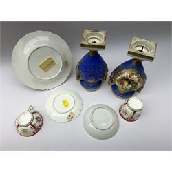 A 19th century Botanical dessert plate, possibly Ridgway, D22cm, together with a 19th century tea cup and saucer, and further cup, each decorated with panels of roses within a claret border, a New Hall type saucer, and a pair of twin handled urns in the manner of Spode, with figural winged handles and hand painted fruit panels upon a blue ground, heightened in gilt, H23cm (7)