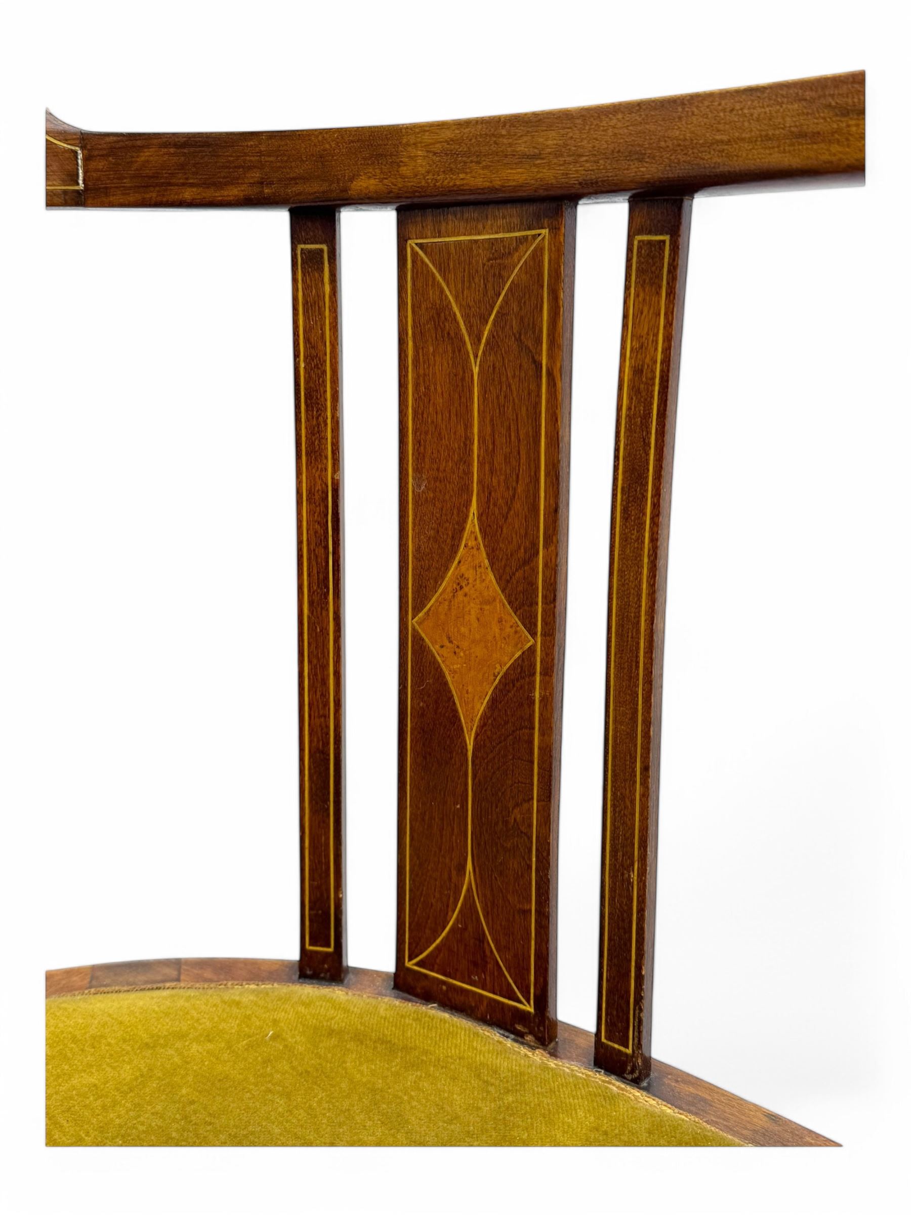 Pair of early 20th century Edwardian inlaid mahogany elbow chairs, shaped top rails with central diamond motif and line inlays, flanked by turned uprights, green velvet seats, on square tapered legs